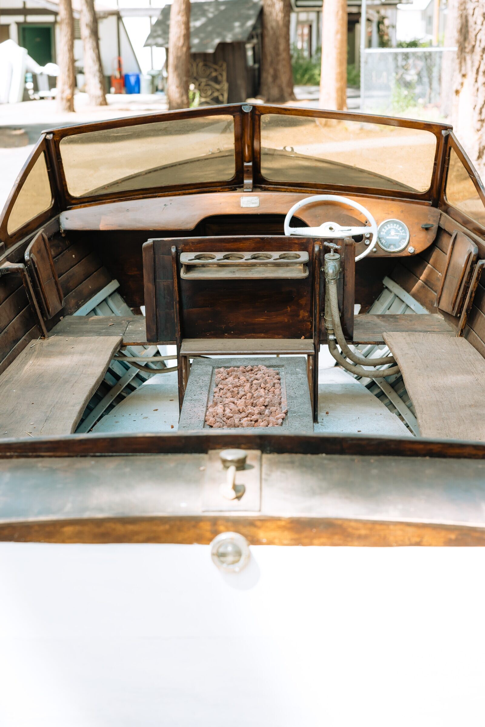 Overhead view of the boat-firepit's brass helm and lava rocks