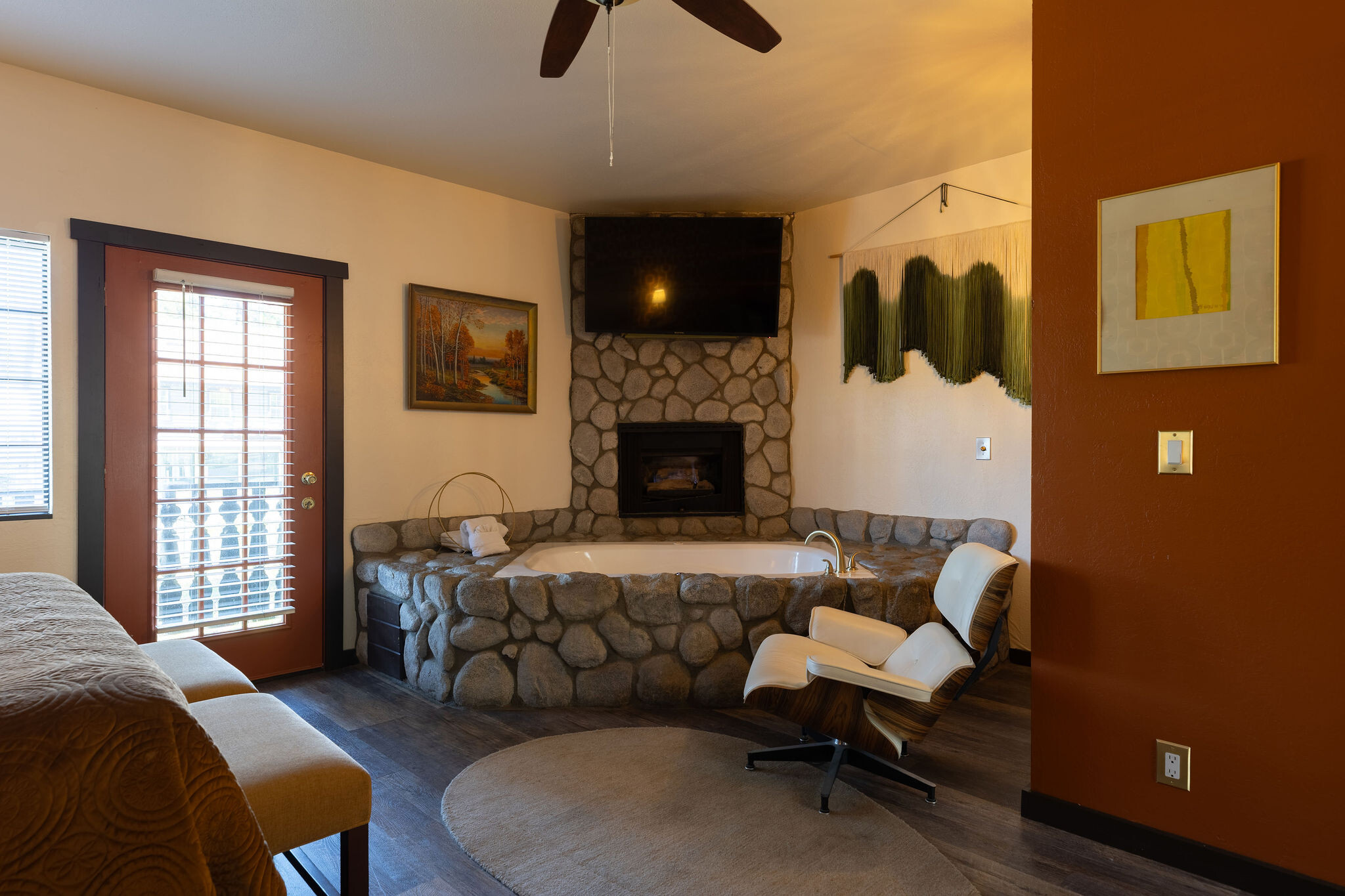 Katy Cabin — Eames lounger by the stone spa tub