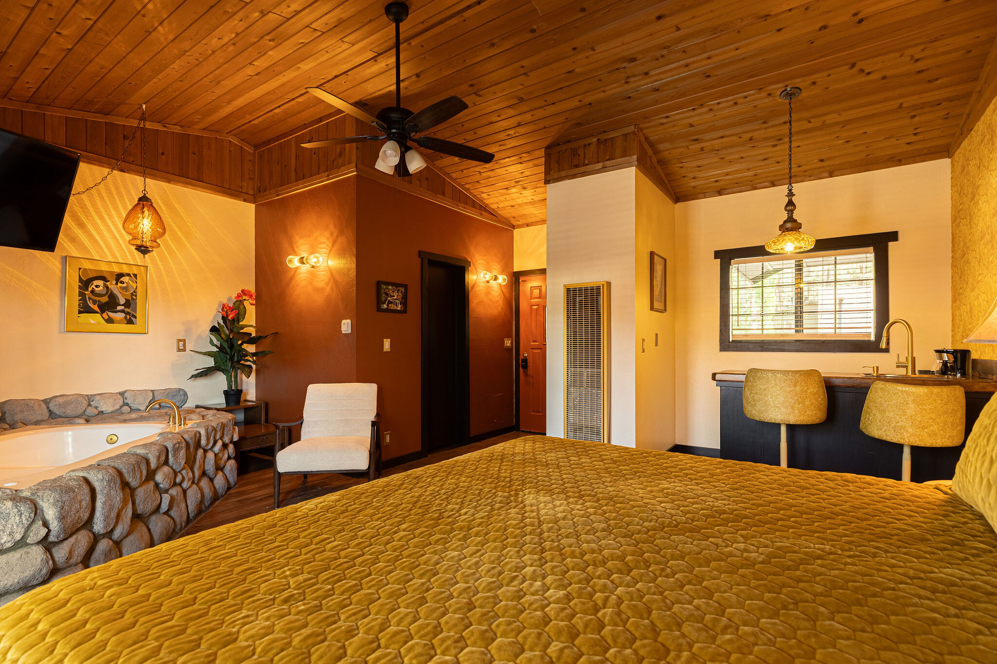 XL Spa Suite — vaulted ceiling, in-room stone spa tub, kitchenette