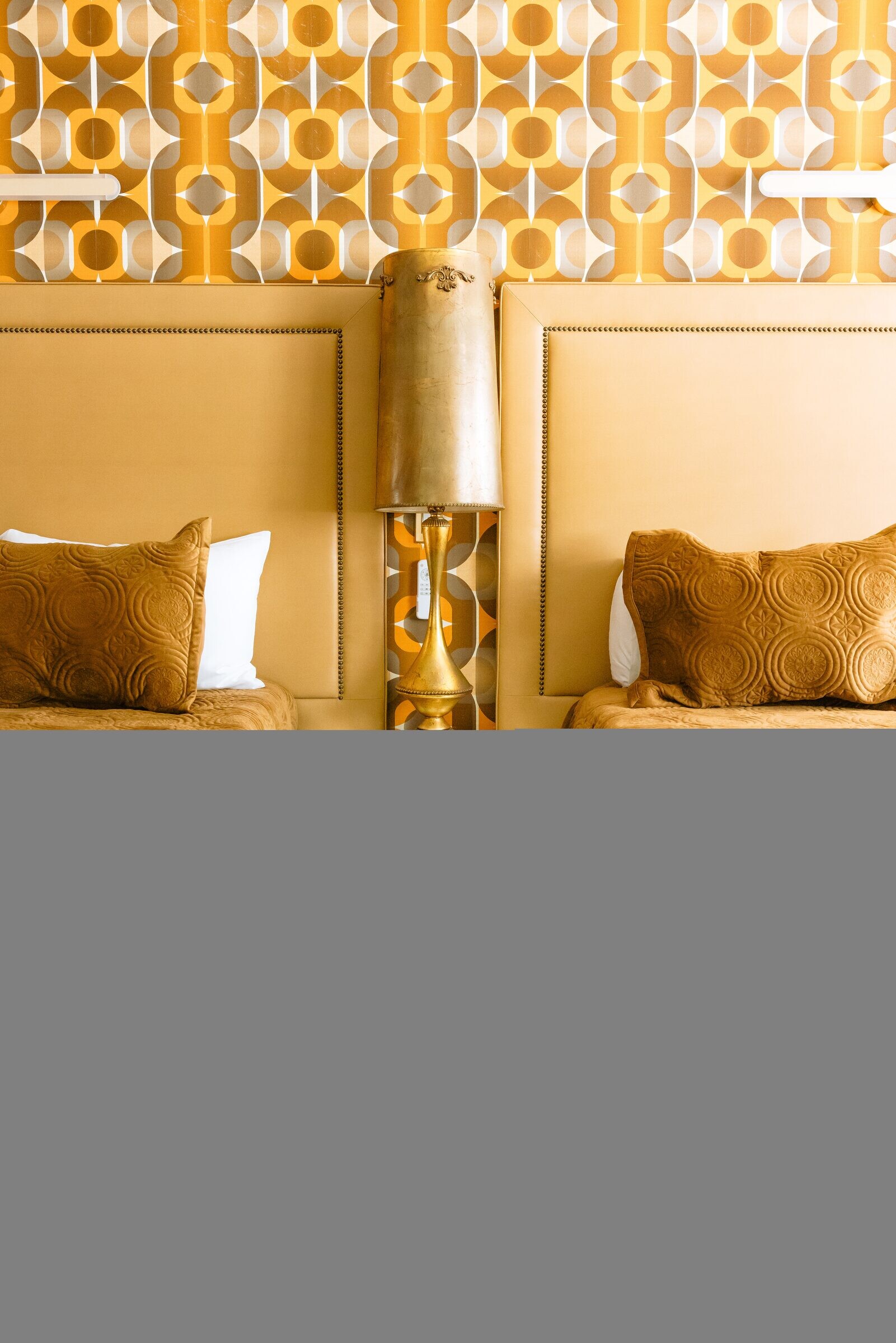 Mustard honeycomb-velvet headboard and pillow detail