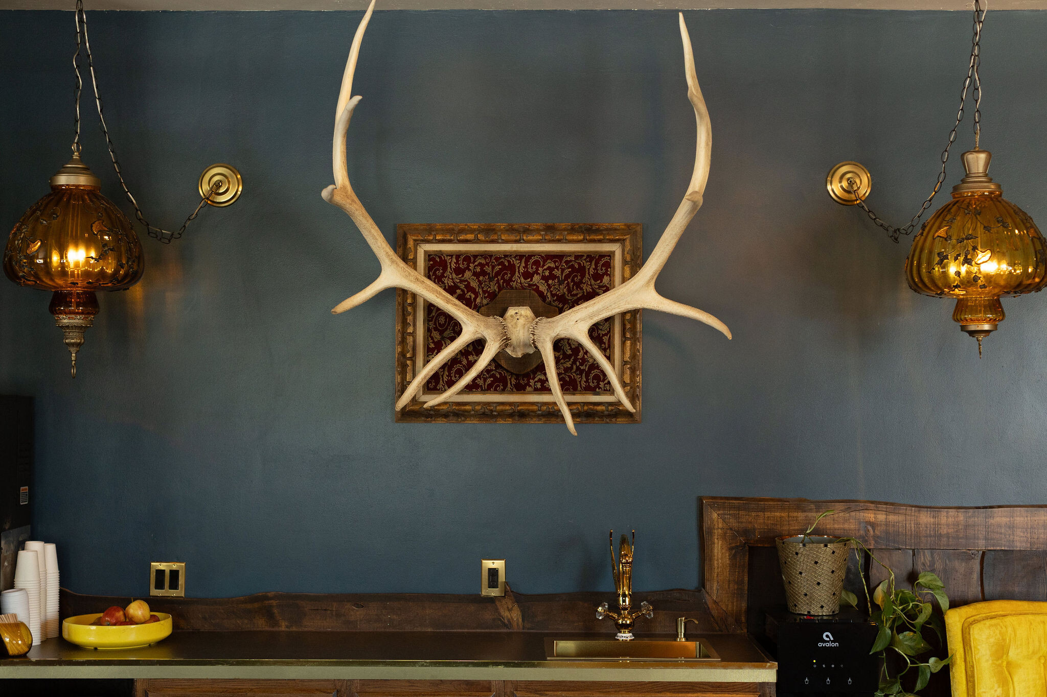 Antler frame and amber swag lantern above the lounge wet-bar