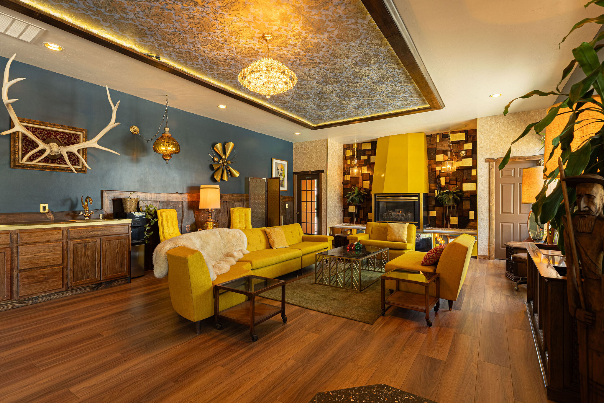Yellow sectional sofa with sheepskin throw under the gold-leaf ceiling