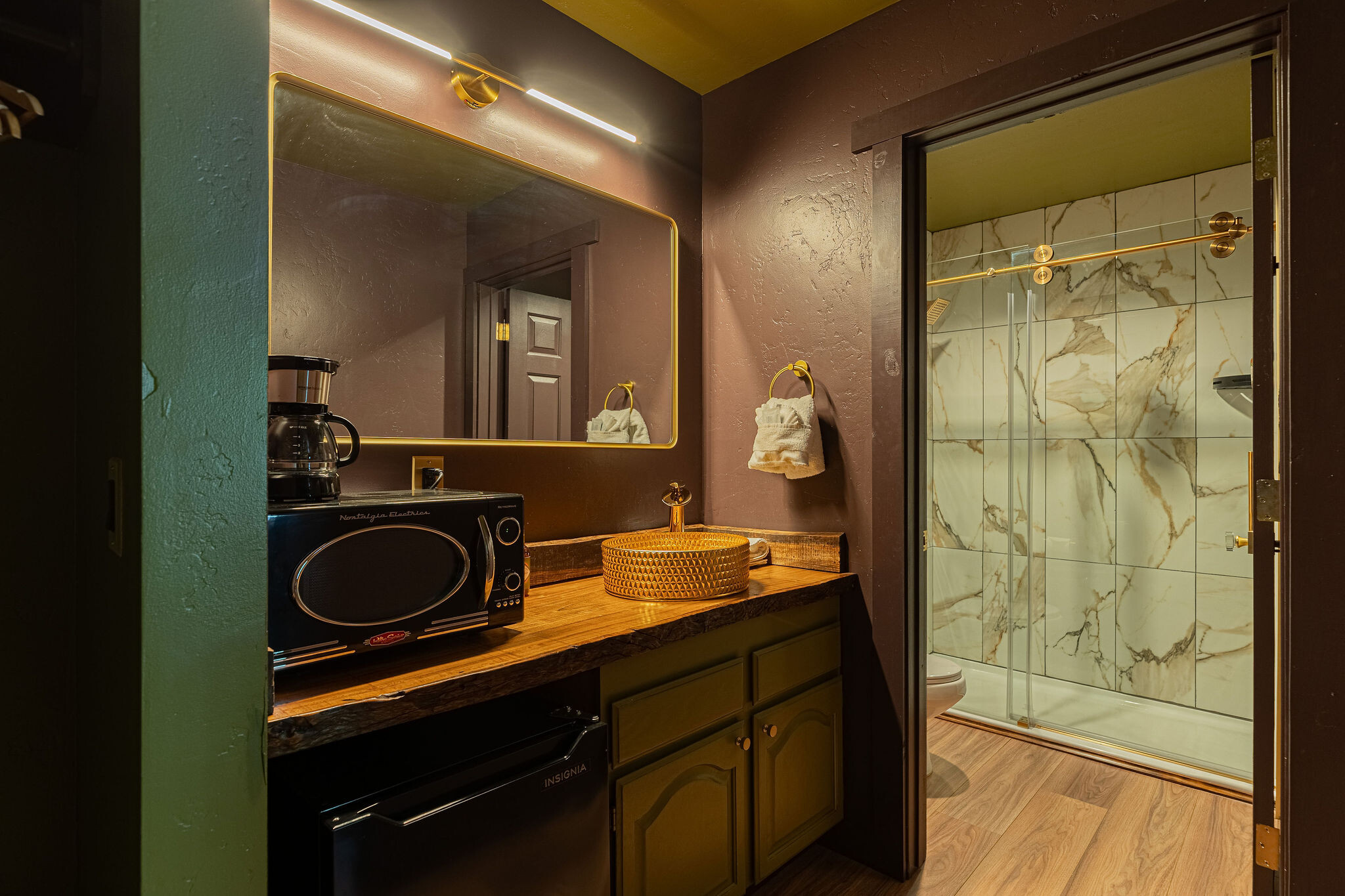 King Studio bathroom — tile, sconces, retro fixtures